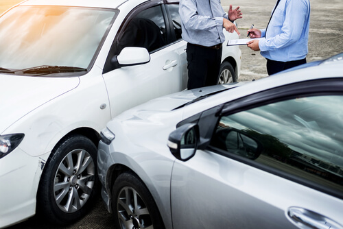 drivers assessing damage after car accident