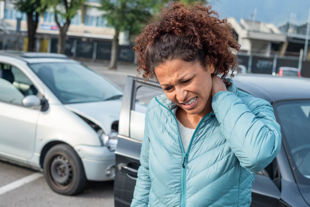 Woman driver suffering from neck injuries from a rear end accident.