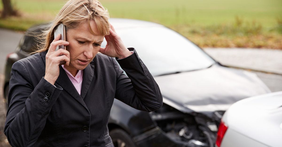 Female driver calling for help due to car accident..