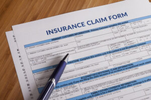 Insurance claim form with ballpoint pen to be filled out