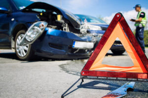 Caution warning sign in the front of car accident.