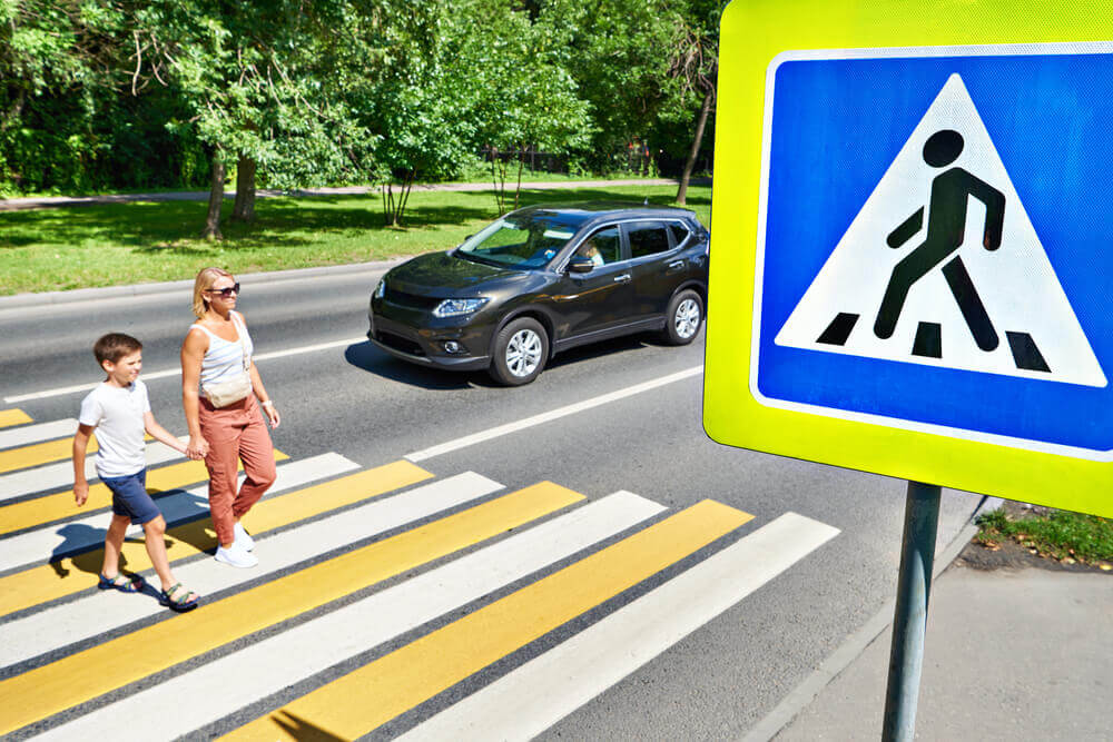 Pedestrian crossing safely in the street.