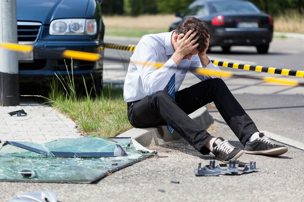 Worried driver on his uninsured car.