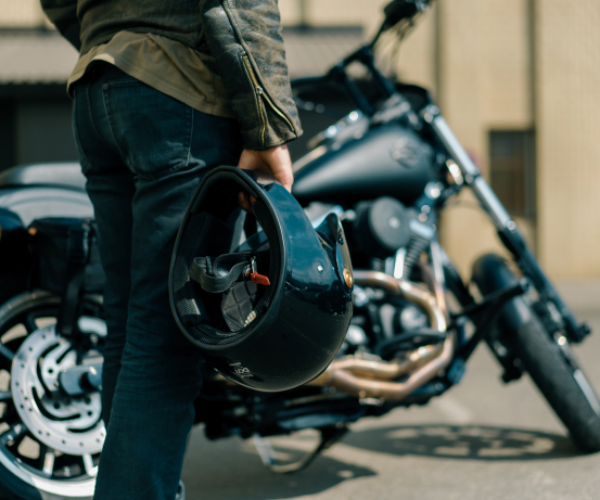 motorcycle rider holding their helmet